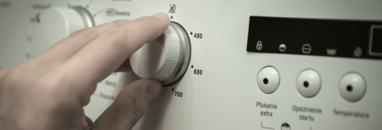 Man choosing the right program on his washing machine