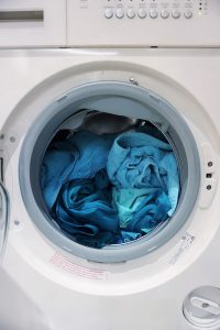washing machine loaded with blue towels