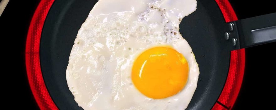 egg cooking in an induction pan