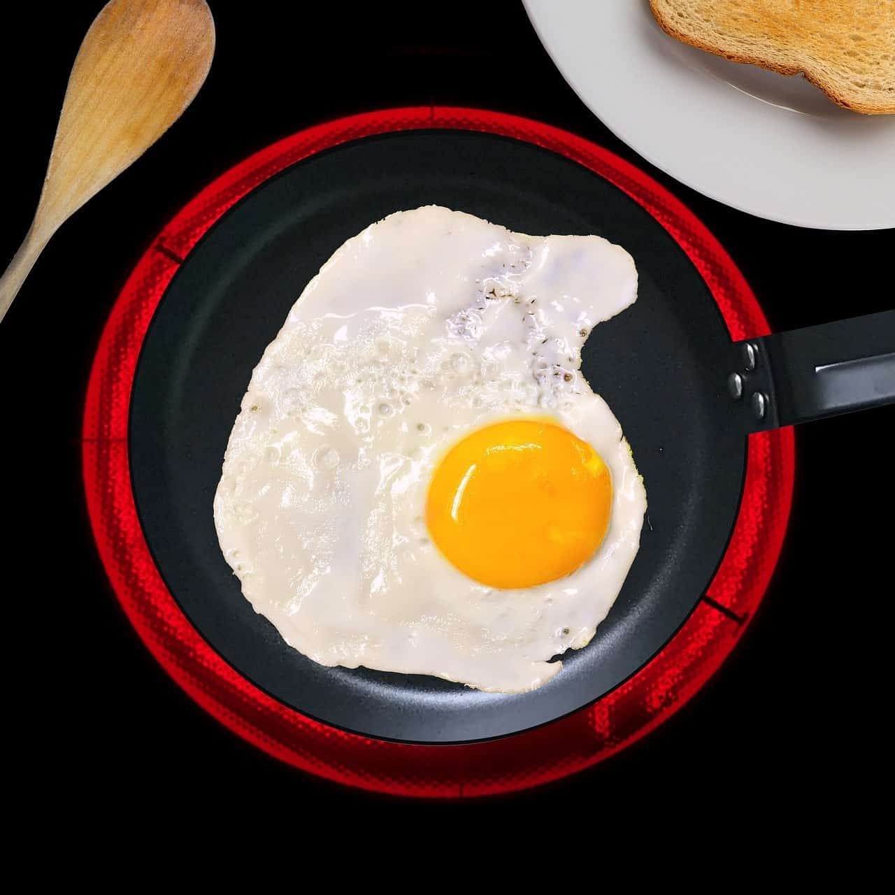 egg cooking in an induction pan