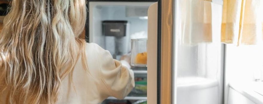 woman infront of fridge