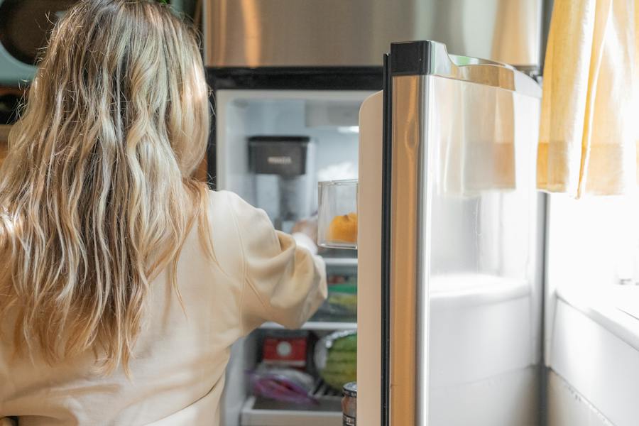 woman infront of fridge