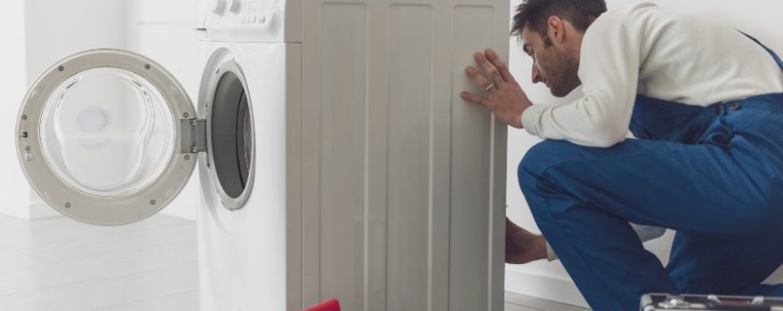 professional repairman fixing a washing machine