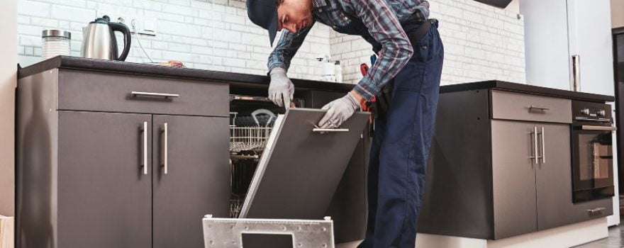 technician repairing a dishwasher